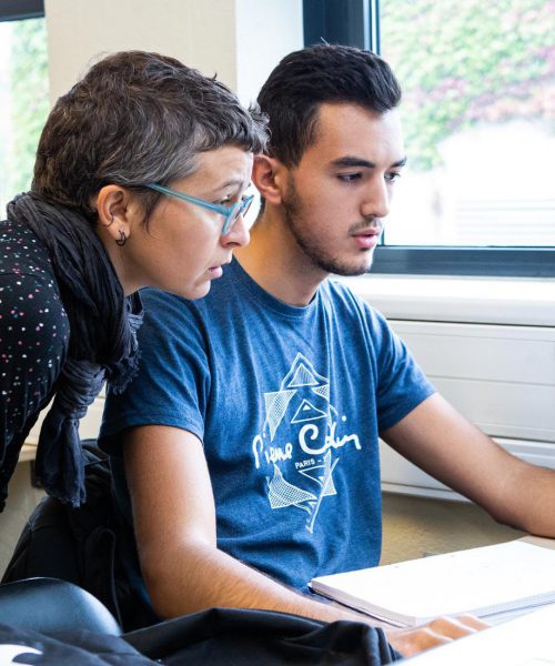 Teacher helping student